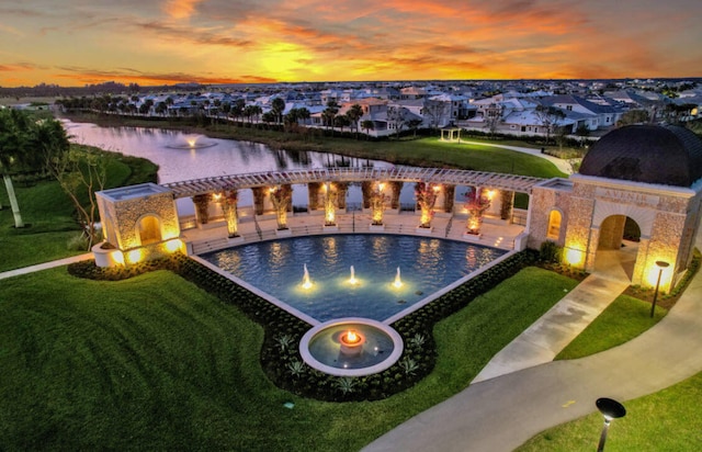exterior space with a water view, a fireplace, and a patio
