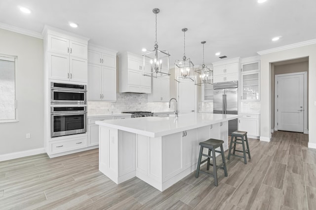 kitchen featuring hanging light fixtures, white cabinetry, a breakfast bar area, and a spacious island