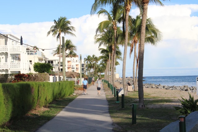 view of community with a water view and a beach view