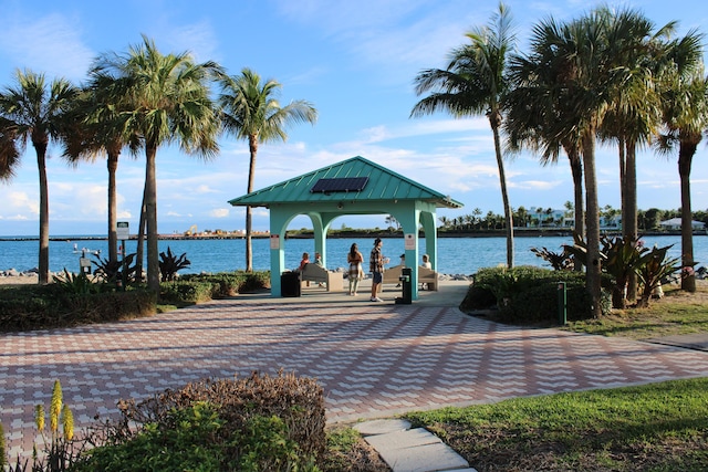 surrounding community with a gazebo and a water view