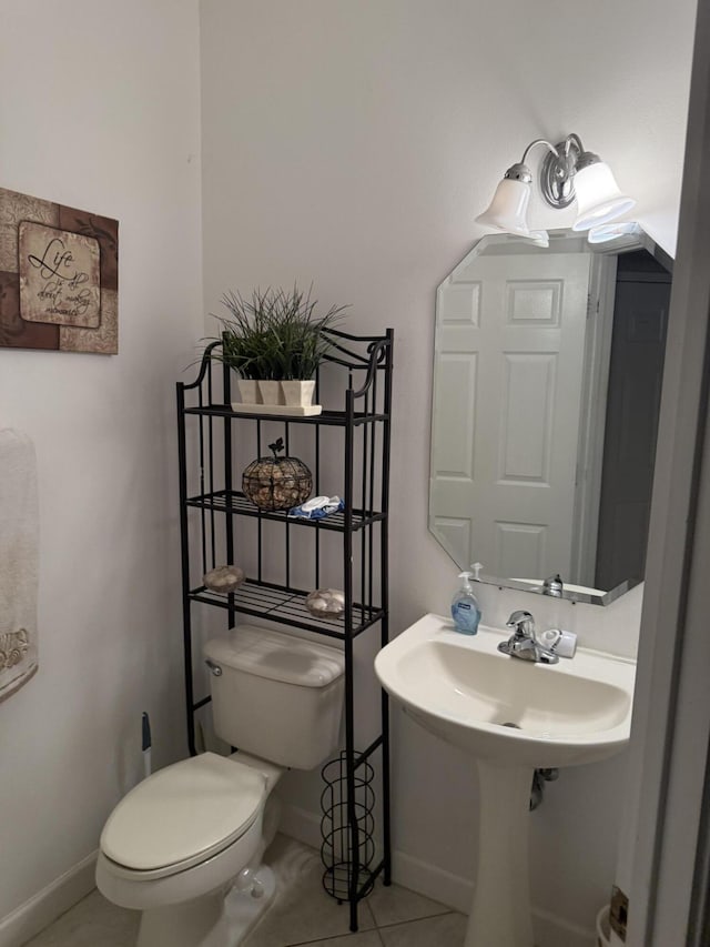 bathroom featuring sink, tile patterned floors, and toilet