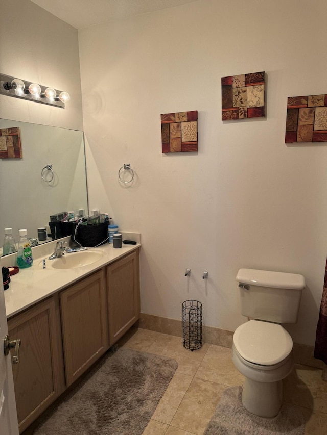 bathroom with tile patterned flooring, vanity, and toilet