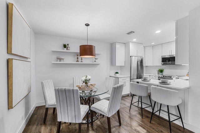 dining room with dark hardwood / wood-style flooring