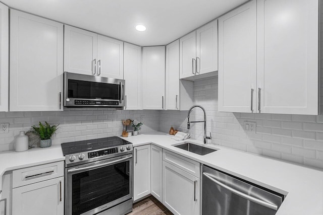 kitchen featuring white cabinetry, appliances with stainless steel finishes, and sink