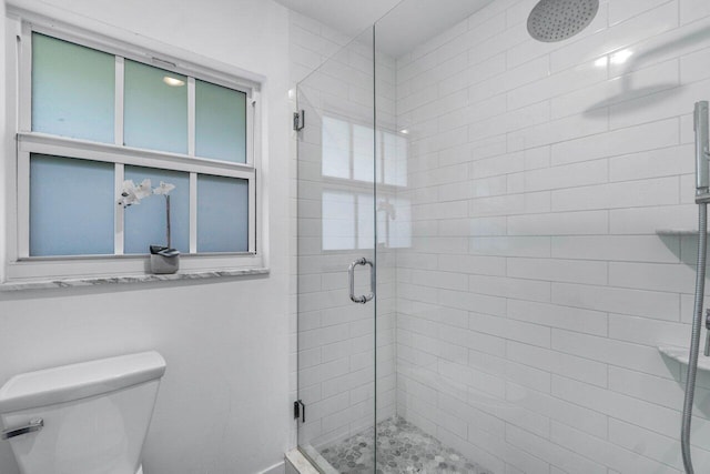 bathroom featuring an enclosed shower and toilet