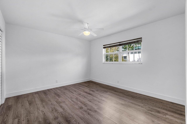 unfurnished room featuring dark hardwood / wood-style floors and ceiling fan