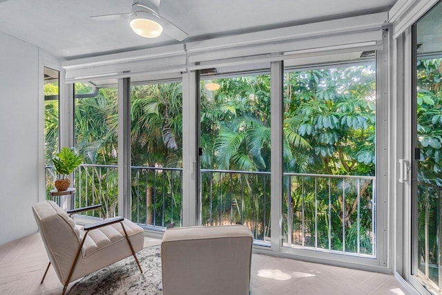 sunroom featuring ceiling fan and a healthy amount of sunlight