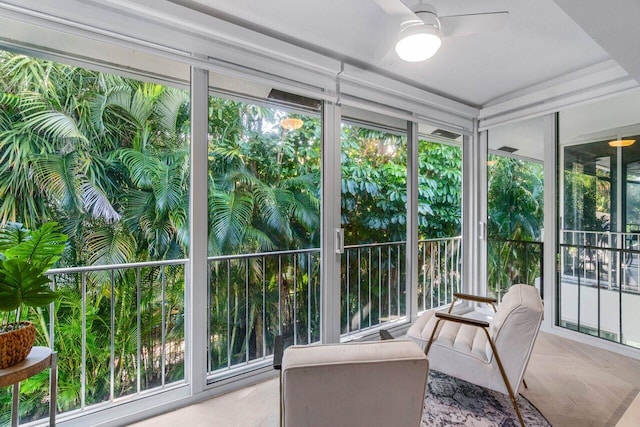 sunroom / solarium featuring plenty of natural light and ceiling fan