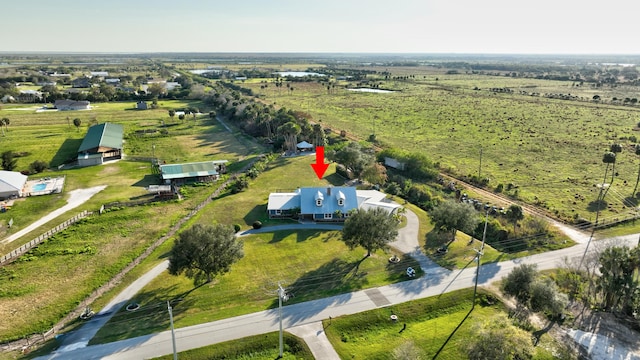 birds eye view of property with a rural view