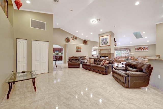 living room with crown molding and high vaulted ceiling