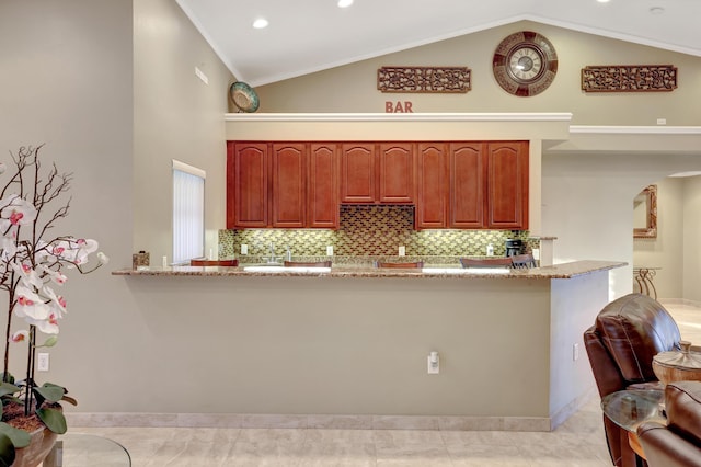 kitchen with tasteful backsplash, light stone countertops, and kitchen peninsula