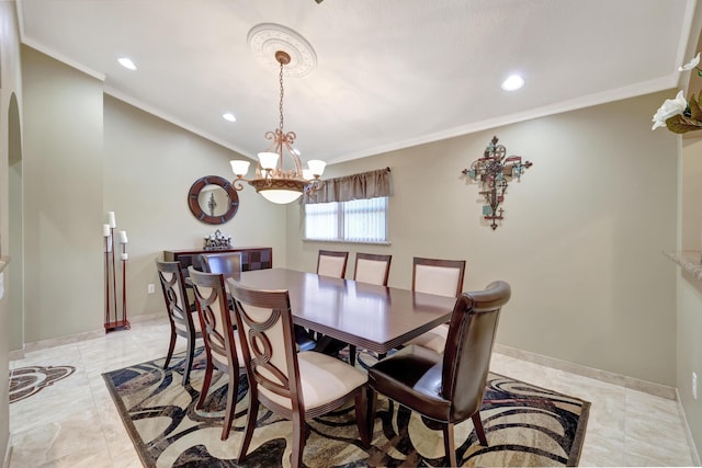 dining room with crown molding and a chandelier