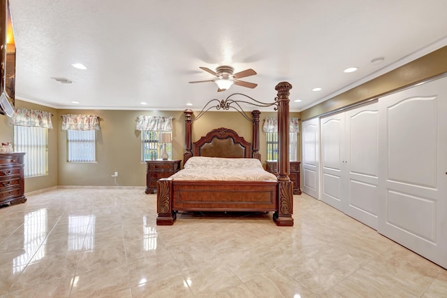 bedroom with crown molding, ceiling fan, and a closet