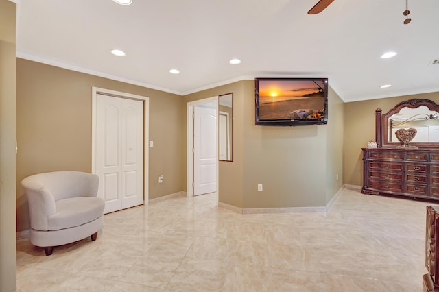 sitting room featuring ornamental molding and ceiling fan