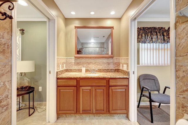 bathroom with vanity and decorative backsplash