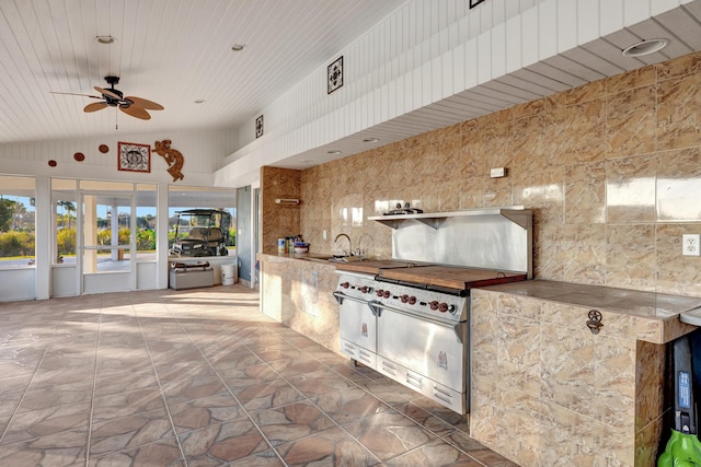 view of patio / terrace featuring an outdoor kitchen, sink, and ceiling fan