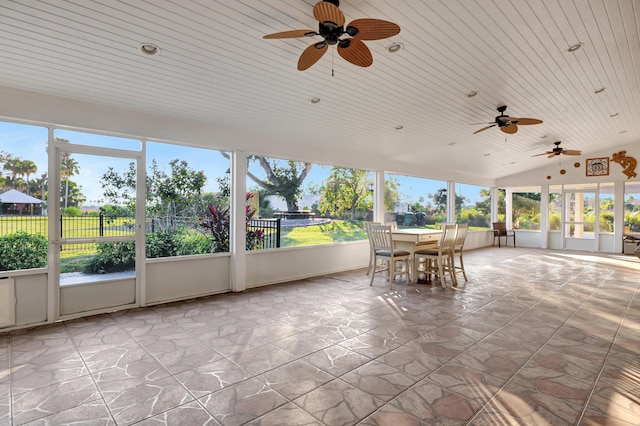 unfurnished sunroom featuring wood ceiling and vaulted ceiling