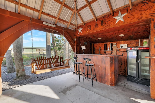 bar featuring vaulted ceiling