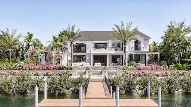 dock area with a balcony and a water view