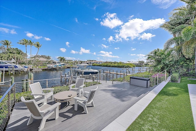 wooden terrace featuring a water view and a boat dock