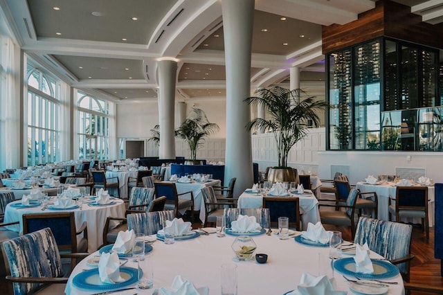 dining area featuring a towering ceiling