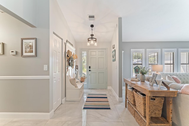 entrance foyer featuring a healthy amount of sunlight and a notable chandelier