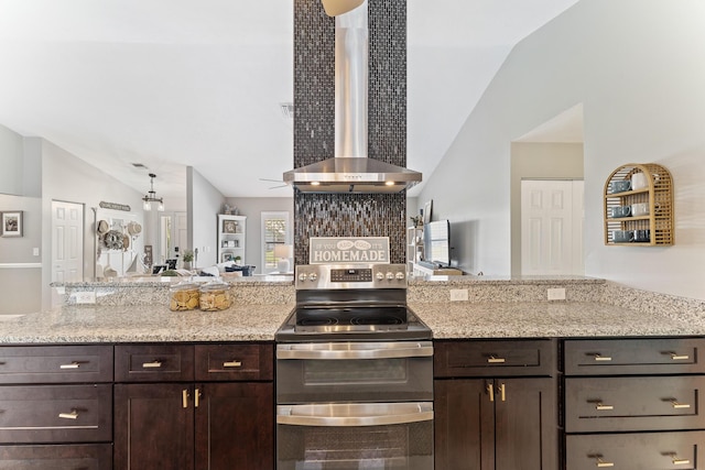 kitchen with range hood, lofted ceiling, range with two ovens, dark brown cabinetry, and light stone countertops