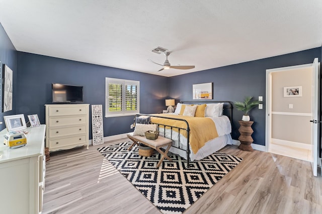 bedroom with light hardwood / wood-style flooring and ceiling fan