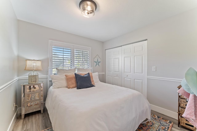 bedroom featuring hardwood / wood-style floors and a closet