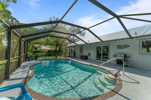 view of pool featuring grilling area, a patio area, and glass enclosure