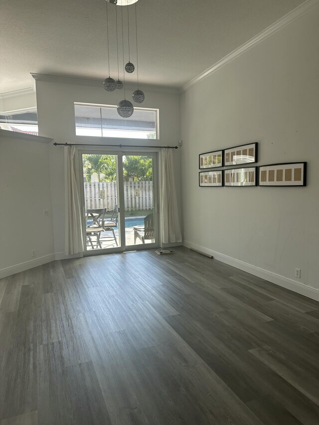 spare room with ornamental molding and dark hardwood / wood-style flooring