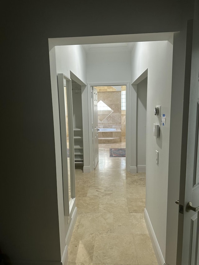 hallway featuring ornamental molding