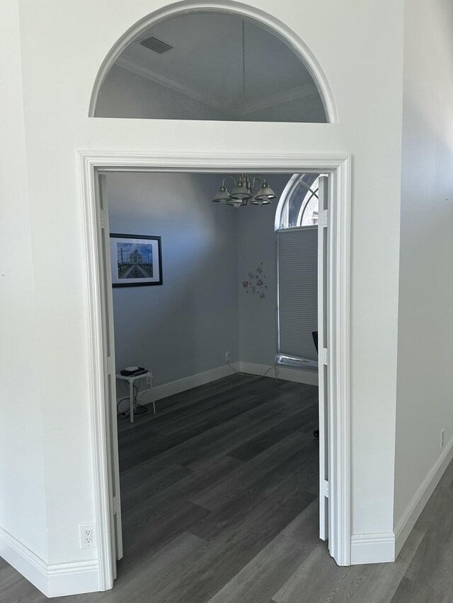 hallway with ornamental molding and dark hardwood / wood-style floors