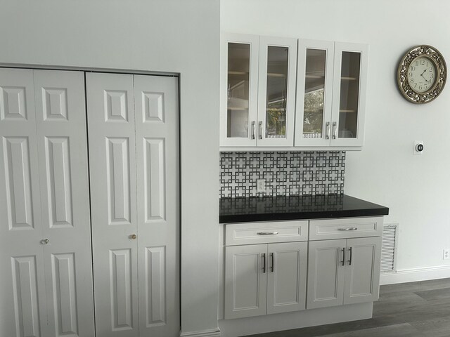 spare room featuring crown molding and dark hardwood / wood-style flooring