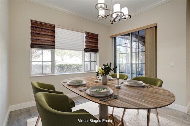 dining room featuring baseboards, crown molding, an inviting chandelier, and wood finished floors