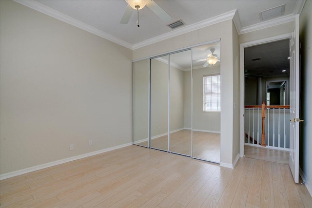 unfurnished bedroom with visible vents, wood finished floors, and ornamental molding