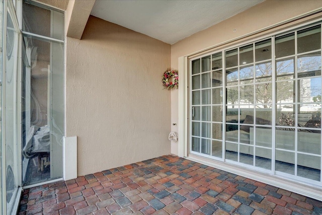 entrance to property featuring stucco siding