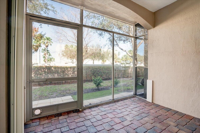 unfurnished sunroom featuring plenty of natural light