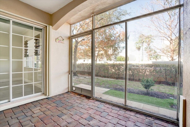 unfurnished sunroom featuring a wealth of natural light