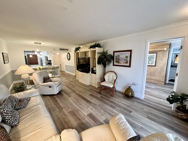 living room with hardwood / wood-style floors and ornamental molding