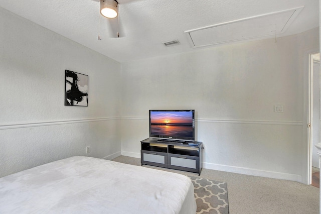 bedroom with carpet, attic access, visible vents, and baseboards