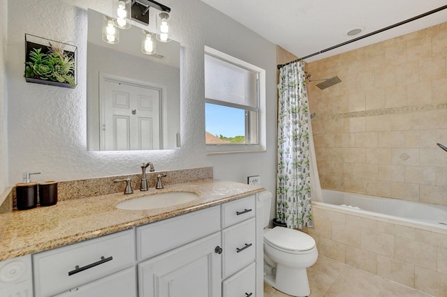 full bath featuring a textured wall, toilet, tiled shower / bath combo, vanity, and tile patterned floors