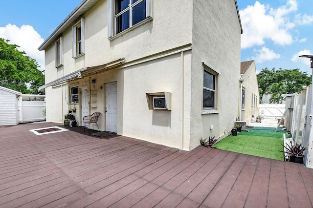 deck featuring a lawn and a fenced backyard