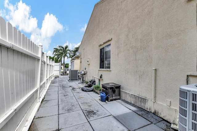 view of patio with fence and central AC unit