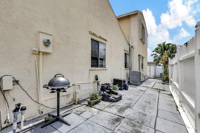 view of patio / terrace featuring cooling unit and a fenced backyard