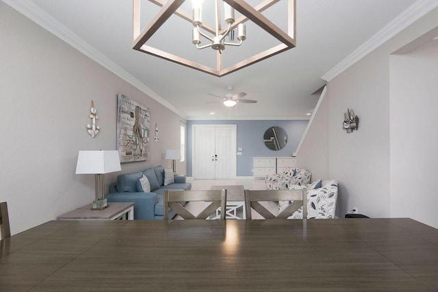 living room featuring crown molding and ceiling fan with notable chandelier