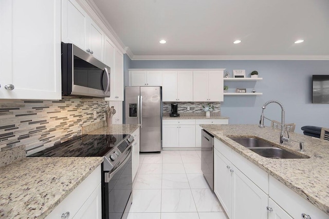 kitchen with white cabinetry, sink, light stone counters, stainless steel appliances, and crown molding