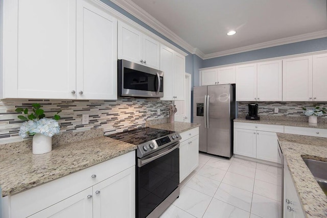 kitchen featuring ornamental molding, white cabinets, and appliances with stainless steel finishes