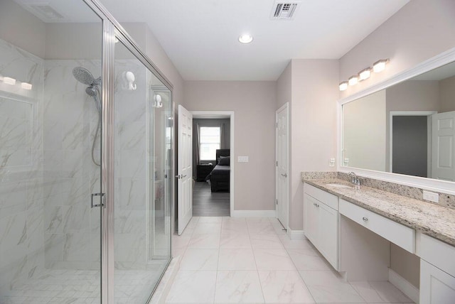 bathroom featuring vanity and a shower with shower door