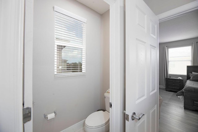 bathroom featuring hardwood / wood-style flooring and toilet